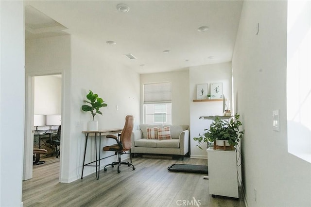 home office with hardwood / wood-style floors