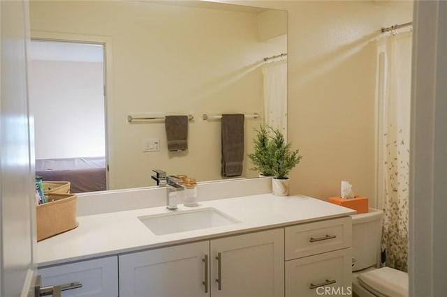 bathroom featuring vanity and toilet