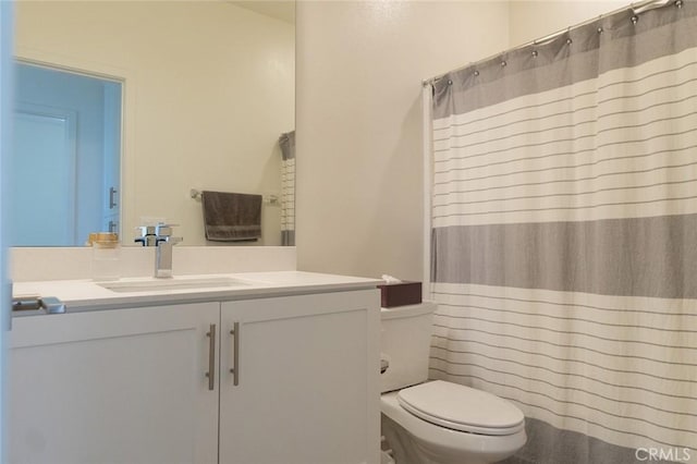 bathroom with toilet, vanity, and a shower with shower curtain
