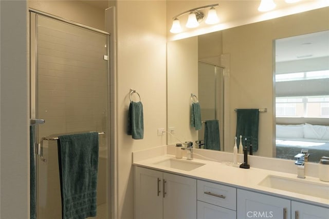 bathroom featuring vanity and a shower with shower door