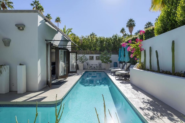 view of swimming pool featuring a patio area