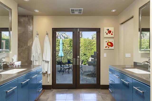 doorway to outside with light tile patterned floors, french doors, and sink