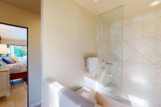 bathroom with tile patterned floors and tiled shower