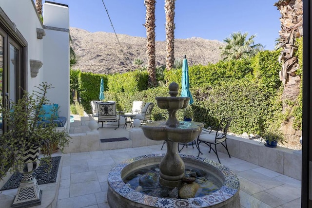 view of patio / terrace featuring a mountain view