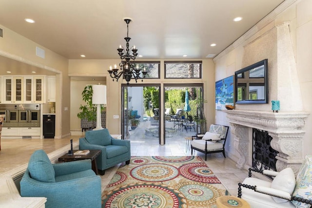 living room with light tile patterned floors, a high end fireplace, and a chandelier