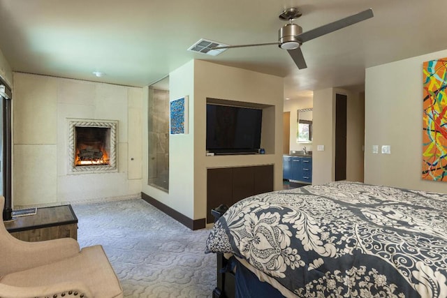 carpeted bedroom featuring ceiling fan and sink