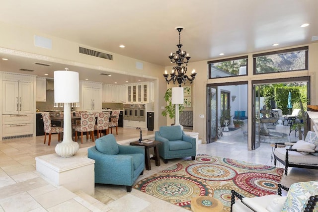 living room featuring light tile patterned flooring and an inviting chandelier