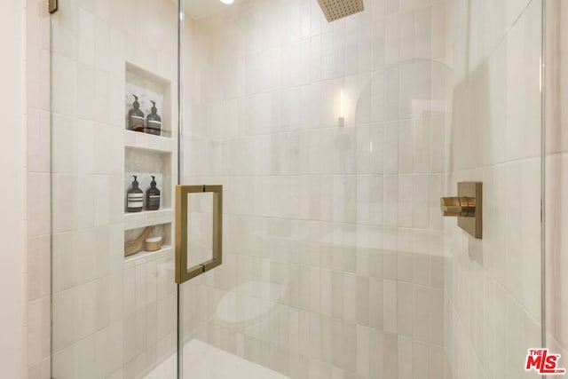 bathroom featuring a shower with shower door