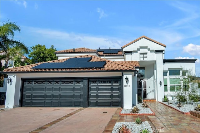 view of front of house with a garage and solar panels