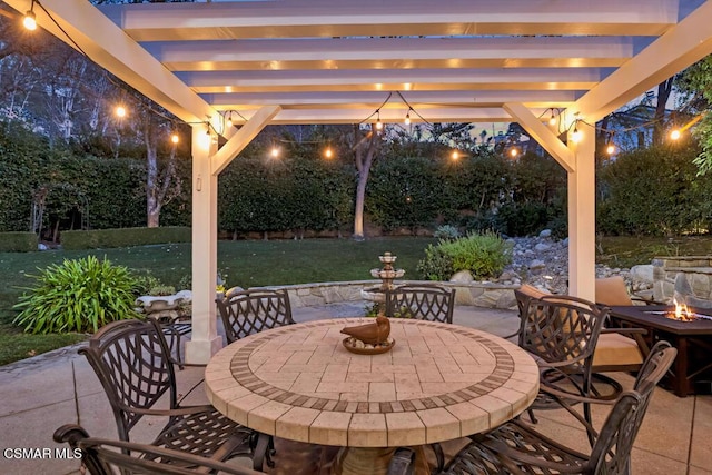 view of patio with a pergola and a fire pit