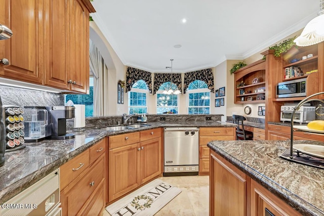 kitchen featuring sink, dark stone countertops, stainless steel appliances, and pendant lighting