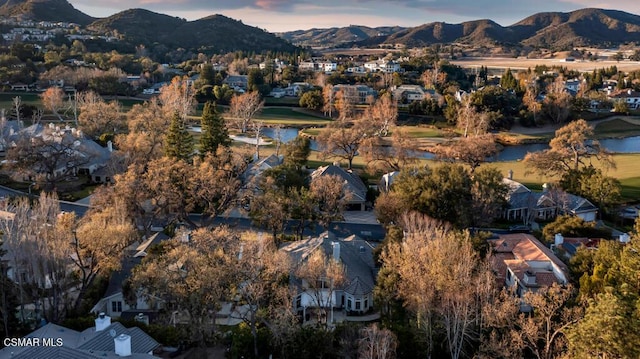 aerial view at dusk featuring a mountain view