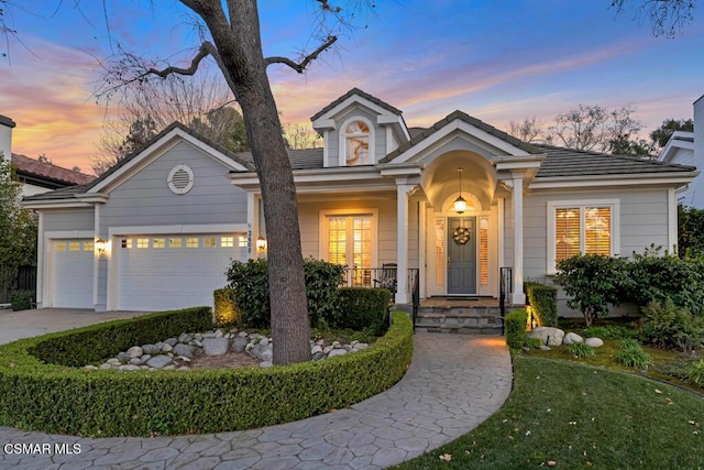 view of front of house featuring covered porch and a garage