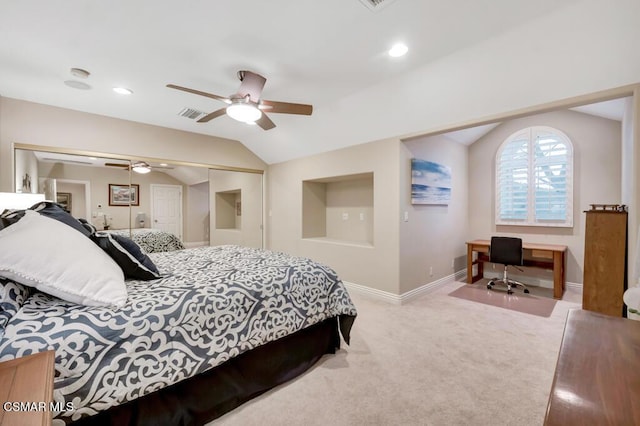 carpeted bedroom with ceiling fan, a closet, and vaulted ceiling