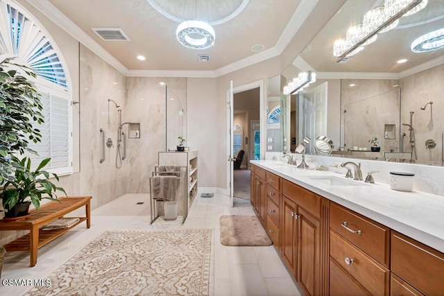 bathroom with a tile shower, tile patterned floors, a chandelier, crown molding, and vanity