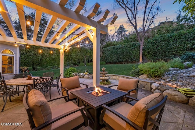 patio terrace at dusk with a pergola and a yard