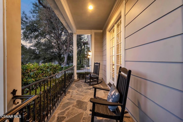 view of balcony at dusk