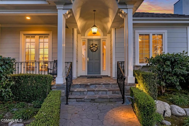 view of exterior entry at dusk