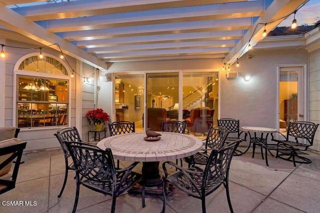 patio terrace at dusk with a pergola