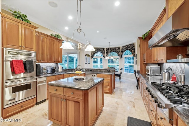 kitchen with a center island, extractor fan, decorative light fixtures, stainless steel appliances, and crown molding