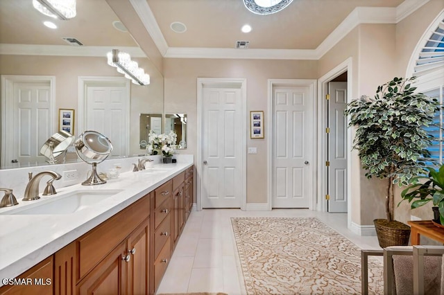 bathroom with tile patterned floors, vanity, and crown molding