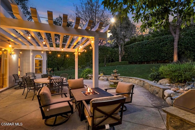 patio terrace at dusk with an outdoor fire pit, a lawn, and a pergola