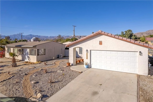 ranch-style house with a mountain view and a garage