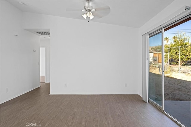 unfurnished room featuring ceiling fan and dark hardwood / wood-style flooring