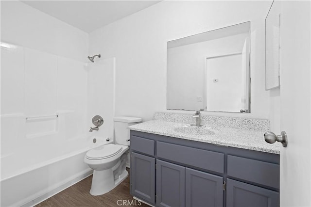 full bathroom featuring wood-type flooring, shower / bathing tub combination, vanity, and toilet