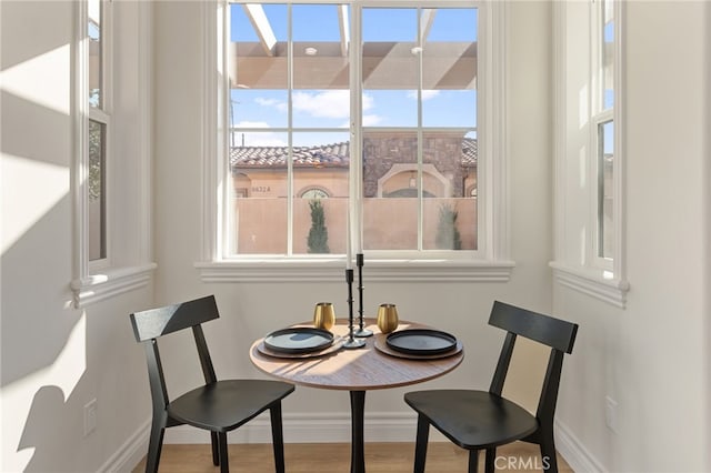 dining space with wood-type flooring