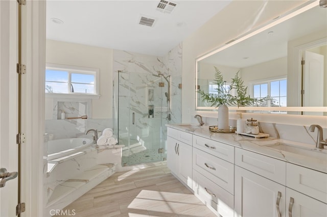 bathroom with wood-type flooring, vanity, plenty of natural light, and plus walk in shower