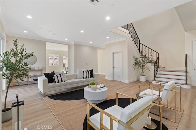 living room featuring light wood-type flooring and ornamental molding