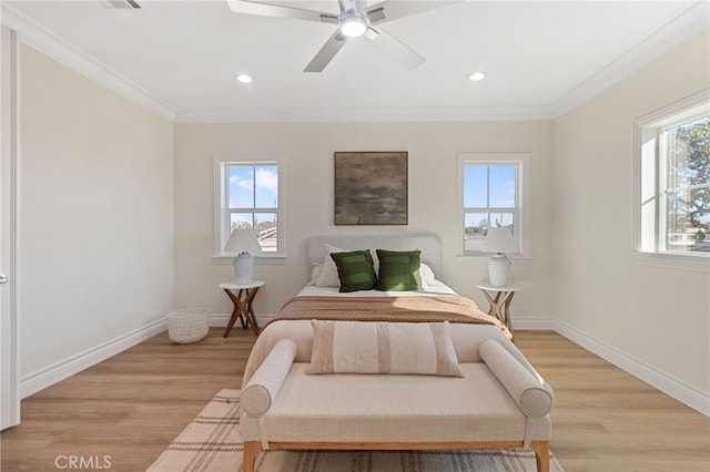 bedroom featuring ceiling fan, crown molding, and light hardwood / wood-style floors