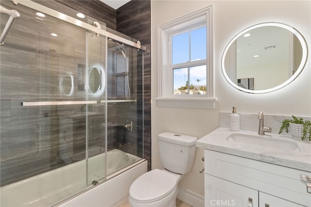 full bathroom with toilet, bath / shower combo with glass door, and vanity