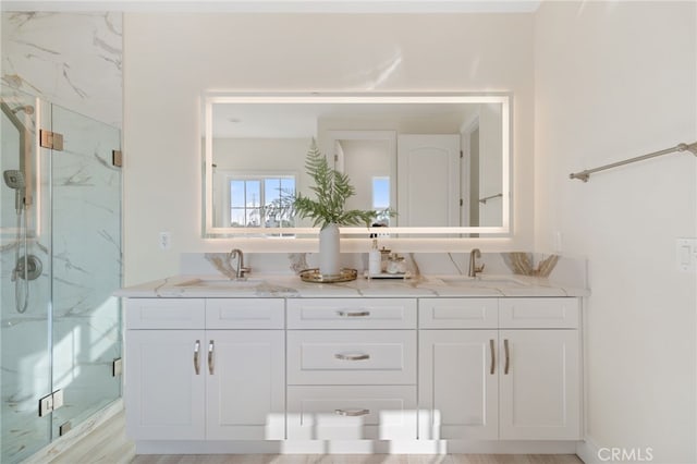 bathroom featuring hardwood / wood-style floors, an enclosed shower, and vanity