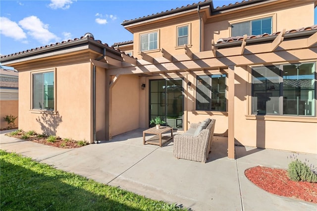 rear view of property featuring a patio area and outdoor lounge area