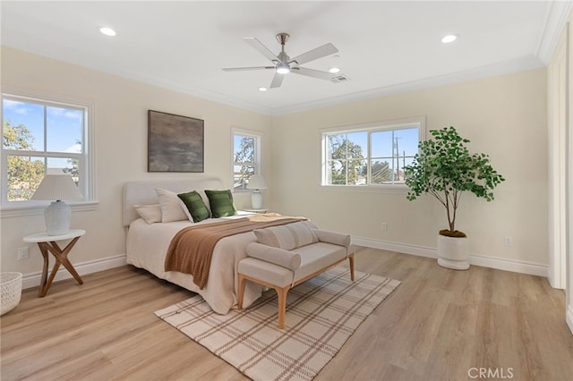 bedroom featuring crown molding, ceiling fan, and light hardwood / wood-style flooring