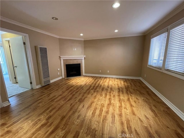 unfurnished living room with crown molding and light wood-type flooring