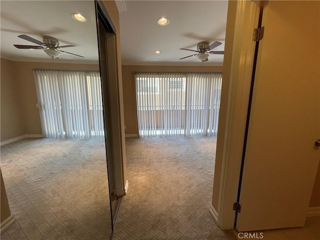 unfurnished room with carpet floors, ceiling fan, and ornamental molding