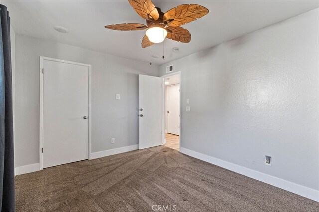 carpeted empty room with ceiling fan