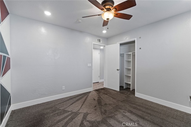 unfurnished bedroom featuring ceiling fan, a closet, and dark carpet