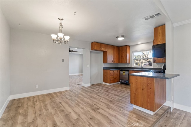 kitchen with range, decorative light fixtures, kitchen peninsula, light wood-type flooring, and stainless steel dishwasher