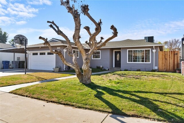 ranch-style home featuring a garage and a front yard