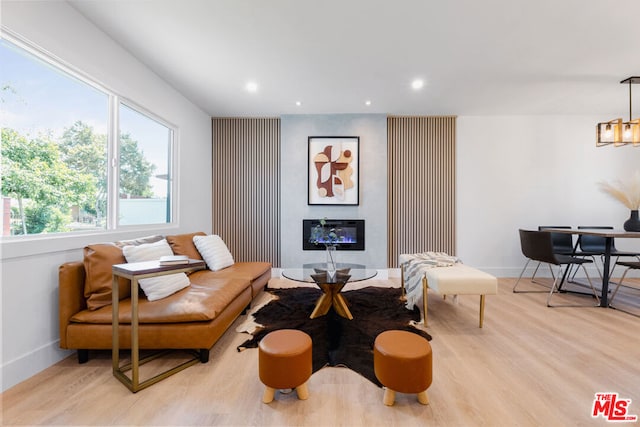 interior space featuring light wood-type flooring and a notable chandelier