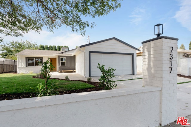 ranch-style home with a garage and a front lawn