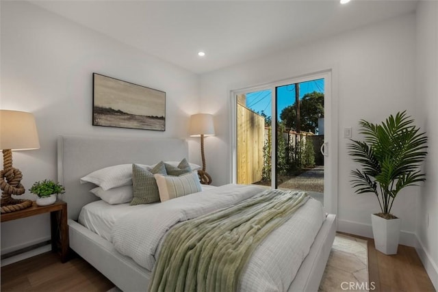 bedroom featuring access to outside and hardwood / wood-style flooring