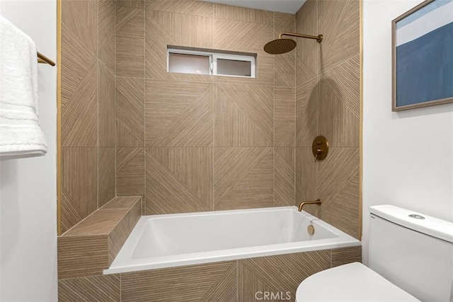 bathroom featuring tiled shower / bath and toilet