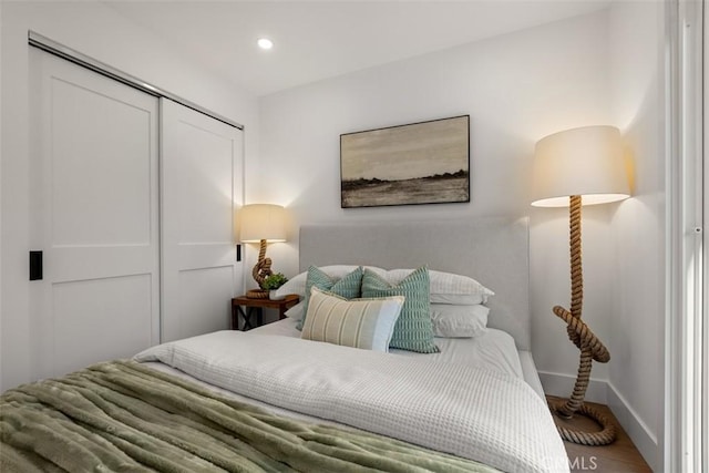 bedroom featuring hardwood / wood-style floors and a closet