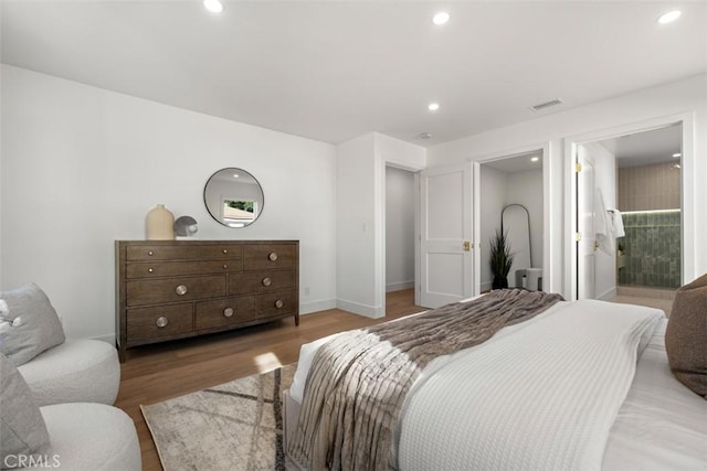 bedroom featuring hardwood / wood-style floors and connected bathroom