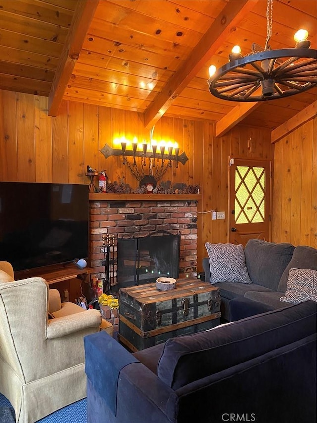 living room featuring a fireplace, beam ceiling, wooden walls, and wooden ceiling